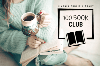 A person in a cozy sweater sits cross-legged holding a ceramic mug and an open book, with a graphic overlay that reads “Livonia Public Library 100 Book Club” beside an open-book icon.