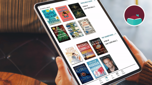 person holding a tablet displaying a digital library app with ebook covers on screen